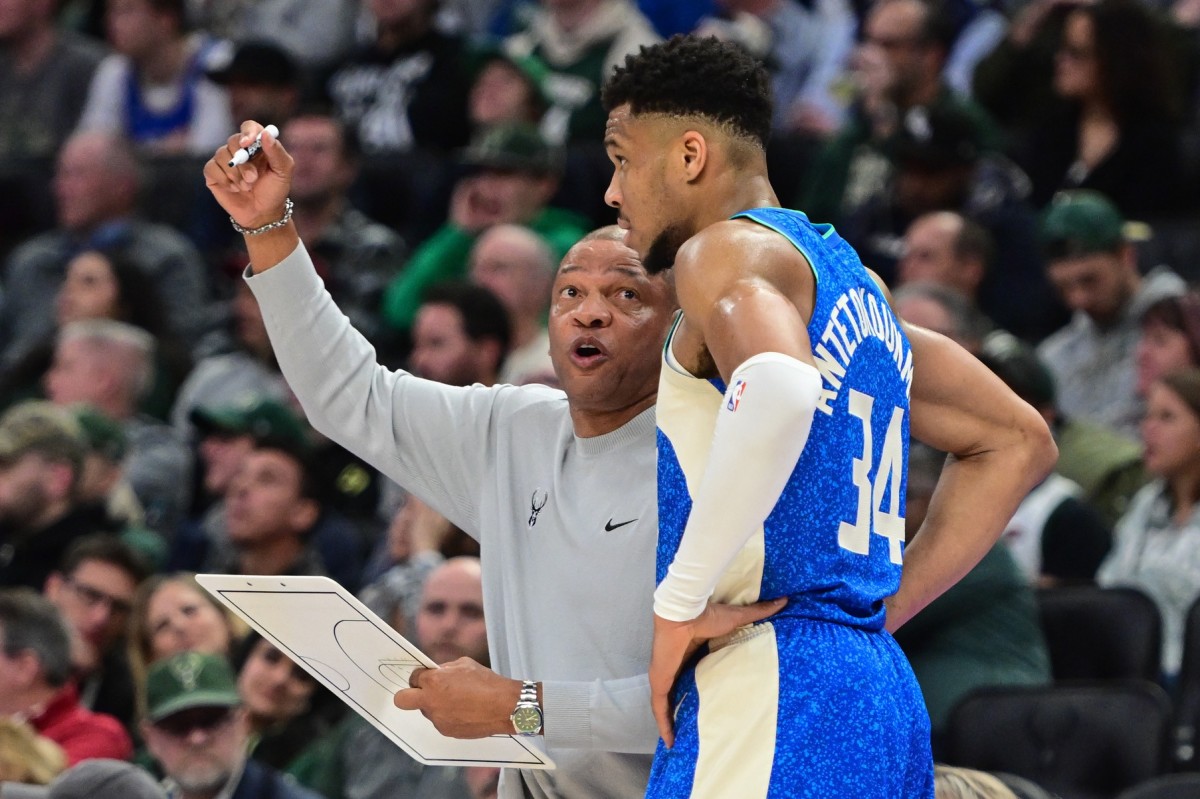 Milwaukee Bucks head coach Doc Rivers draws up a play with forward Giannis Antetokounmpo (34) 